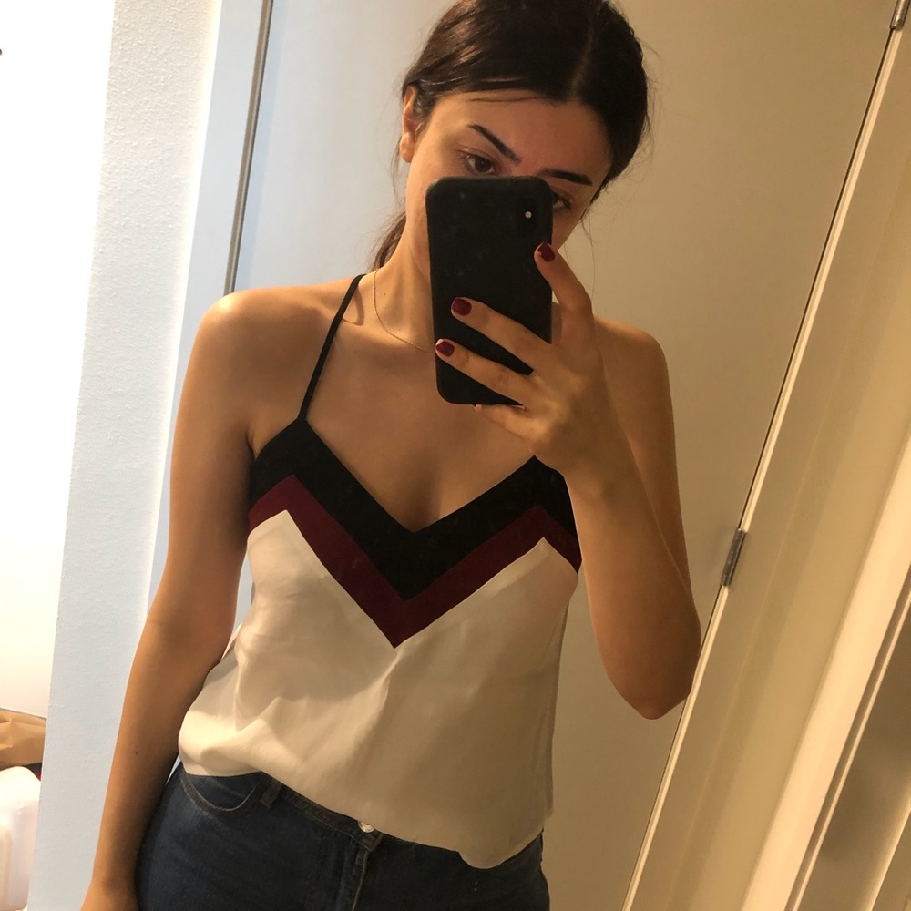 White V-neck top.
